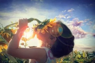 Beautiful little girl and sunflower