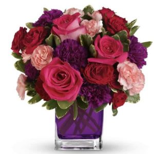 dark pink roses with darek purple and light pink flroal accents in purple glass vase