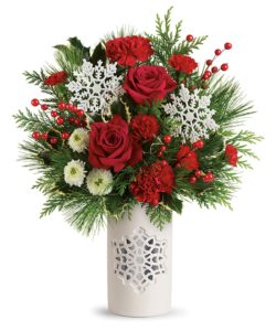 red roses and white mums with winter greens in white vase