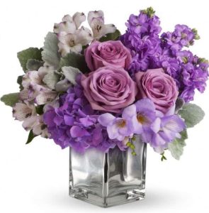 lavender roses with purple stock and orchids in vase