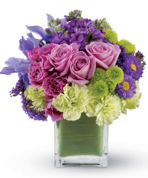 Express your passion with this mod bouquet of lavender roses, blue iris and asters, accented with touches of chartreuse. It’s the perfect gift for a loved one – and the cool tones and modern leaf-lined glass block vase make it an excellent choice for men, too!