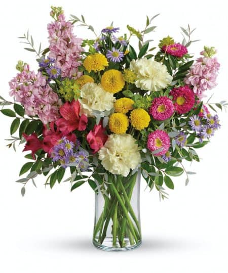 This beautiful bouquet includes red alstroemeria, light yellow carnations, pink stock, hot pink matsumoto asters, large lavender monte cassino asters, yellow button spray chrysanthemums, bupleurum, huckleberry, and parvifolia eucalyptus. Delivered in a clear vase. Approximately 16 1/2" W x 17" H