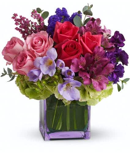 This exquisite mix of feminine blooms is like a breath of fresh air! Sweet pinks and purples are contrasted with a modern burst of fresh green hydrangea, and finished off with a pretty lavender cube vase lined with a tropical aspidistra leaf. It's a fun pick-me-up to send anytime, anywhere! A wide variety of blooms – roses, alstroemeria, hydrangea, stock, freesia, statice and heather.