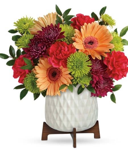 Two gorgeous gifts in one! Celebrate any occasion with this bouquet of bright blooms, stylishly presented in a mod mid-century ceramic planter keepsake! This bright bouquet features hot pink roses, peach gerberas, hot pink carnations, green cushion spray chrysanthemums, purple cushion spray chrysanthemums, and huckleberry. Delivered in a Mid Mod Geometric Planter. Approximately 13 1/2" W x 13 3/4" H