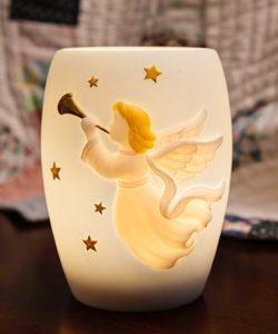 This beautifully sculpted Angel with Stars vase lamp makes a unique bereavement gift. This soft yet gentle angle blowing a golden horn is flying through the soft blue sky along with golden stars. Measures 5"h x 4"w and includes a 15-watt bulb.
